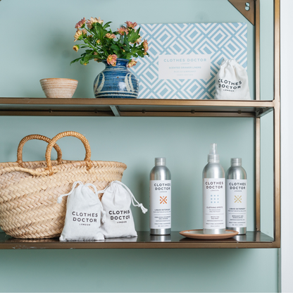 Shelf with 'Clothes Doctor' products, a woven basket, and decorative items against a light blue wall.