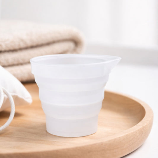 White ceramic cup on a wooden tray with a neutral background