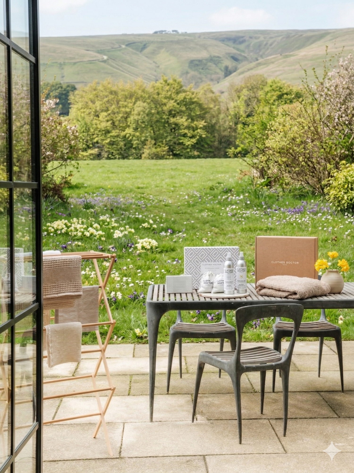 Outdoor patio set with chairs and table on a patio overlooking a scenic landscape.